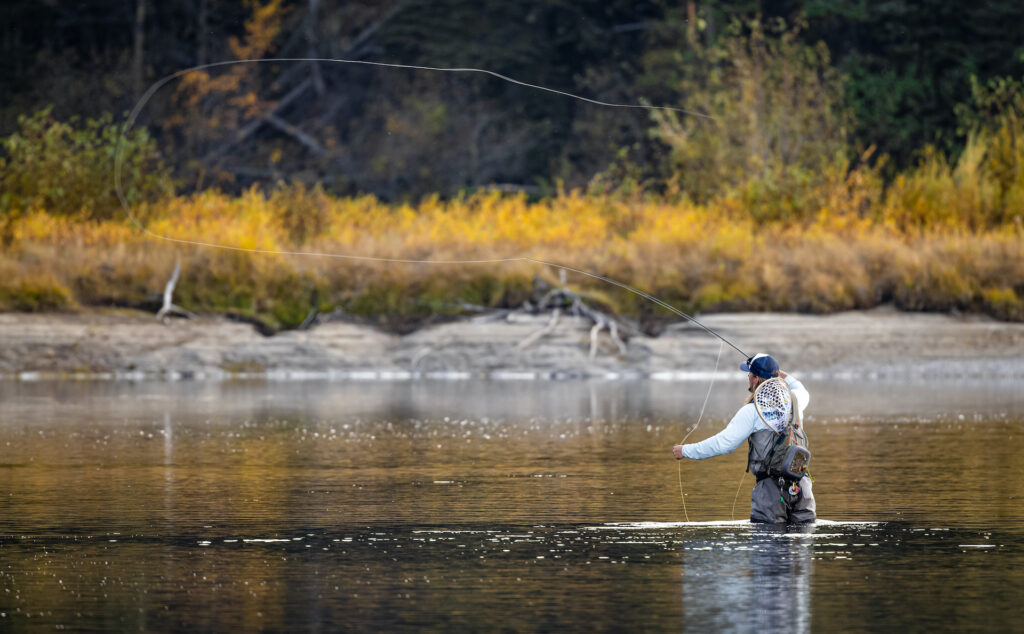 Fly fisherman wearing waders in the Sacramento River.